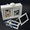 A white rotating flip photocard display frame with two viewing windows and a decorative top