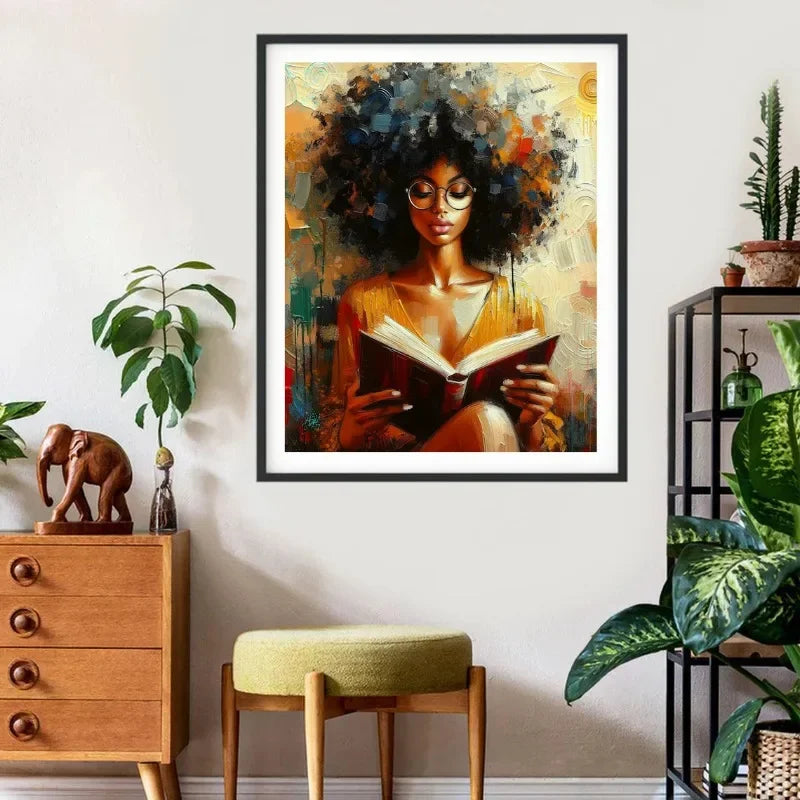 Canvas wall art featuring an African American woman with dark curly hair reading a book in warm tones.