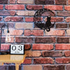A black cat silhouette against a crescent moon on a brick wall with a clock displaying June 03.