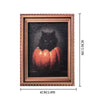 A framed artwork featuring a black cat silhouette against a dark background with orange pumpkins.
