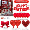 A set of red foil heart-shaped birthday balloons with bows and a loose cluster of red rose petals.