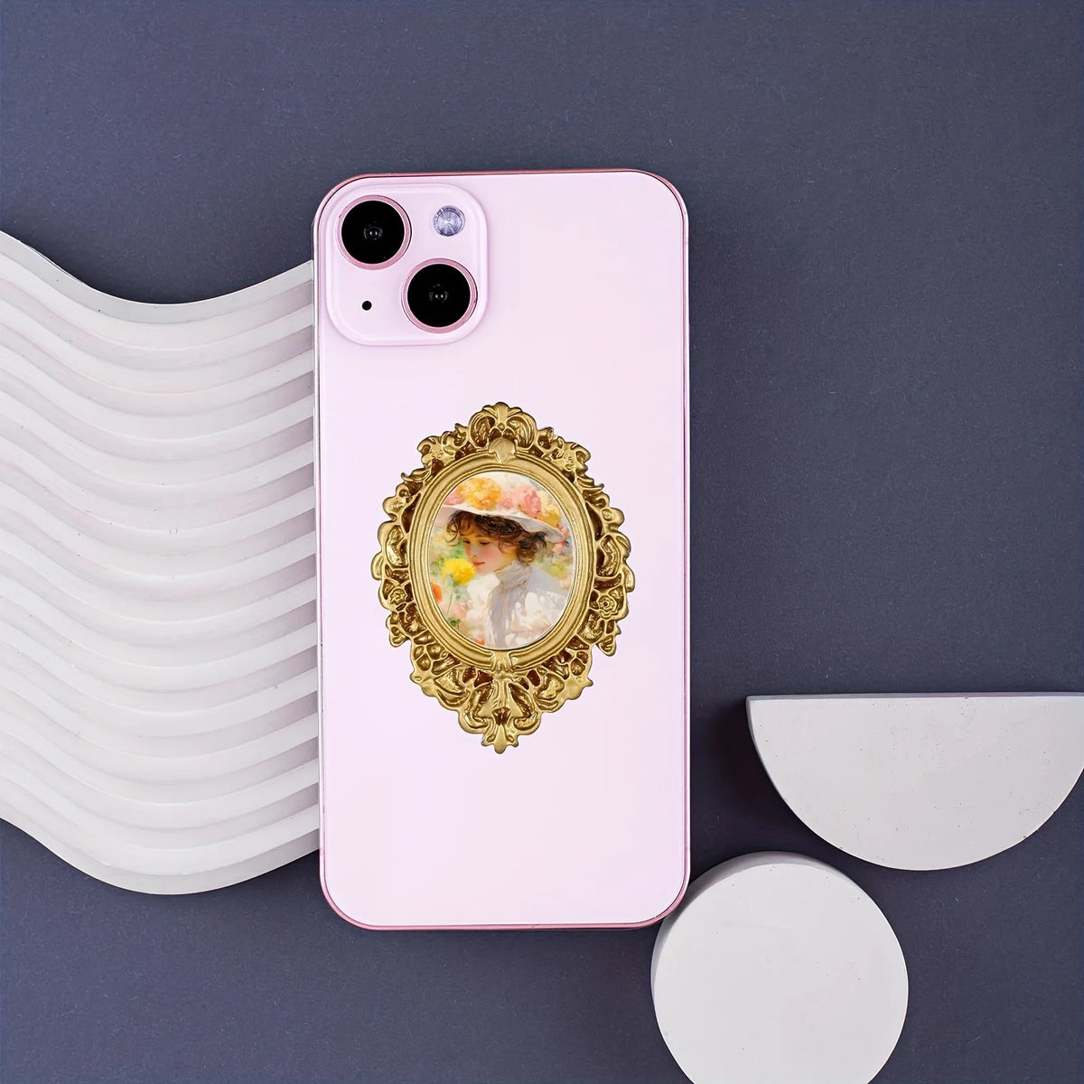 A pink smartphone displaying a vintage gold-framed picture of a woman's face against a dark gray background.