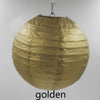 A large, round golden paper lantern suspended by a wire.