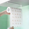 A roll of white paper with small carrot illustrations is being held against a light green tiled wall.