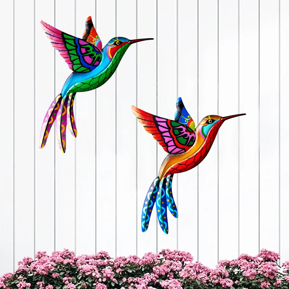 Vibrant metal hummingbird wall art featuring iridescent green, blue, and magenta feathers against a white background.