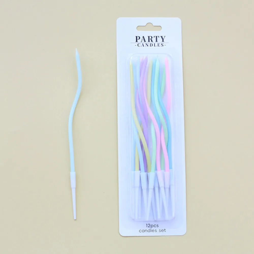 A pack of 12 pastel colored spiral birthday cake candles with star toppers in a white cardboard display box.