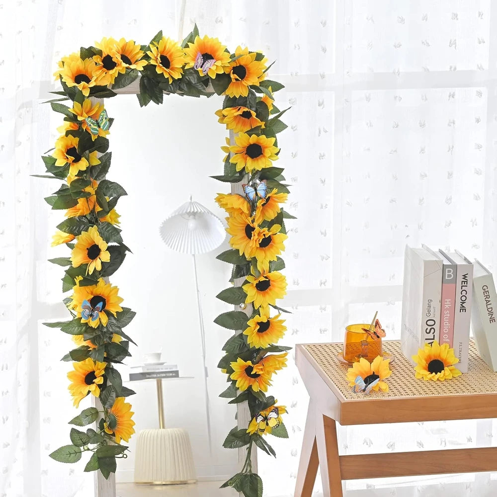 A vertical garland of silk yellow sunflowers and green leaves used for home decor or weddings.