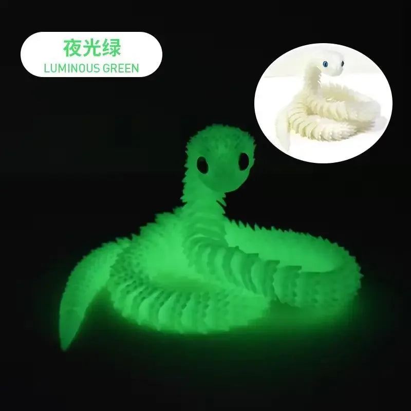 A luminous green 3D printed articulated snake fidget toy resting on a dark background.