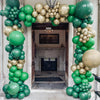 An archway decorated with green and gold latex balloons for party or event decor.