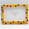 A yellow and brown block photo frame with a square opening, decorated with small star-shaped blocks.