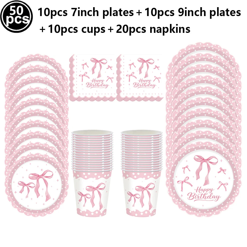 A set of pink disposable party tableware including 7 inch and 9 inch plates, cups, and napkins with bow decorations.