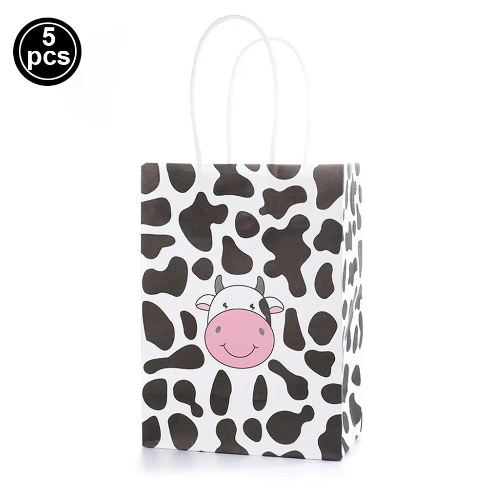 A white paper bag featuring a black and white cow print design with a pink face.