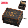A carved wooden music box with a lid engraved A Bela Féra and a separate box featuring the Beauty Beast theme.