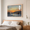 A framed painting of sailboats on water at sunset hanging above a wooden bed.