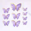 A collection of purple butterfly cake toppers with gold accents for parties and baking.