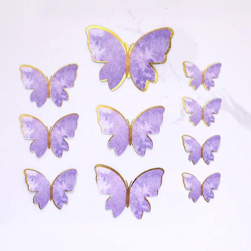 A collection of purple butterfly cake toppers with gold accents for parties and baking.