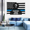 A custom photo American flag tapestry displayed on a wall above a blue sofa.