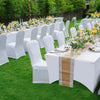 White stretch fitted spandex table covers with floral centerpieces set up for an outdoor event.