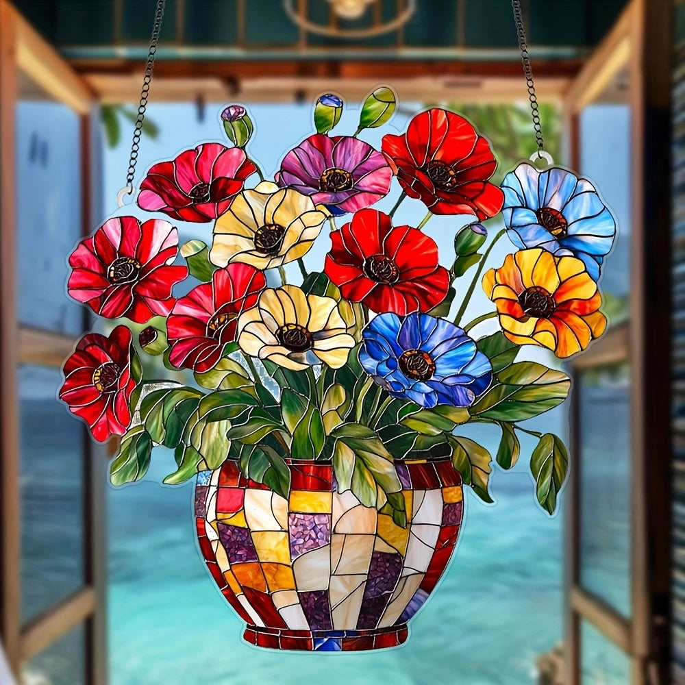 A colorful arrangement of red, yellow, and blue acrylic flowers in a pot hanging as a window ornament.