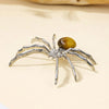 Handcrafted crystal spider figurine with silver legs and a golden body