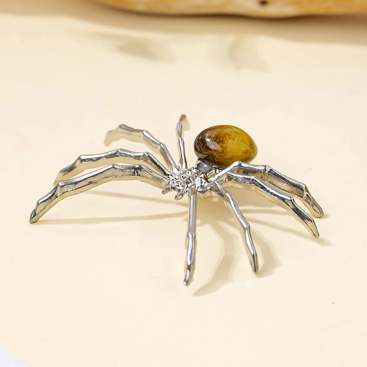 Handcrafted crystal spider figurine with silver legs and a golden body