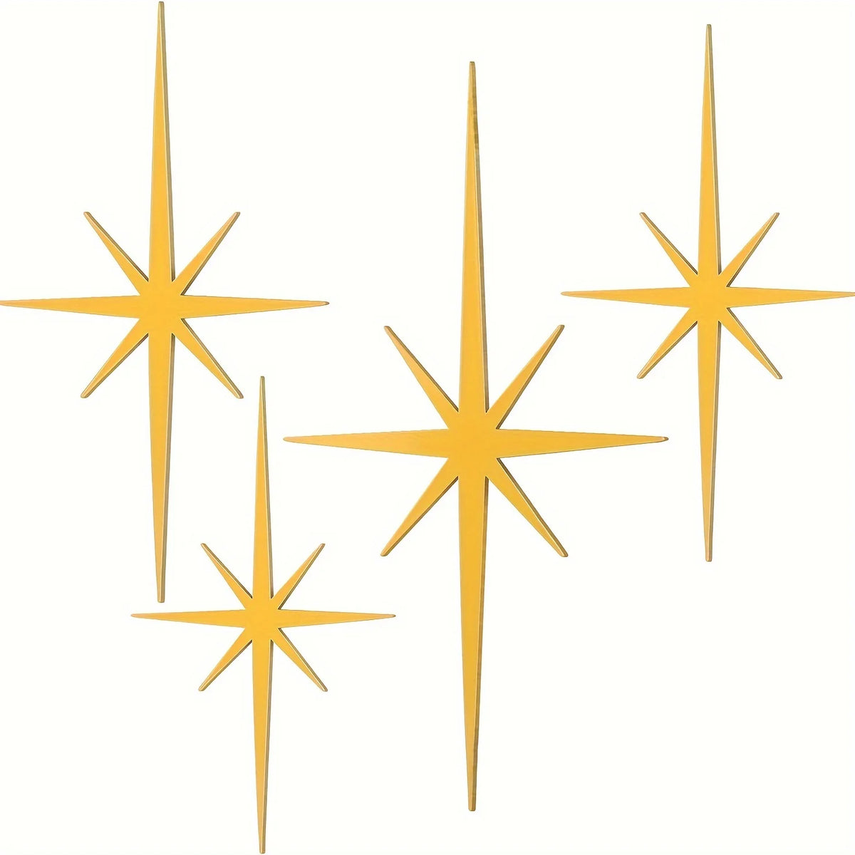 A set of four golden metal star wall art pieces with pointed rays.
