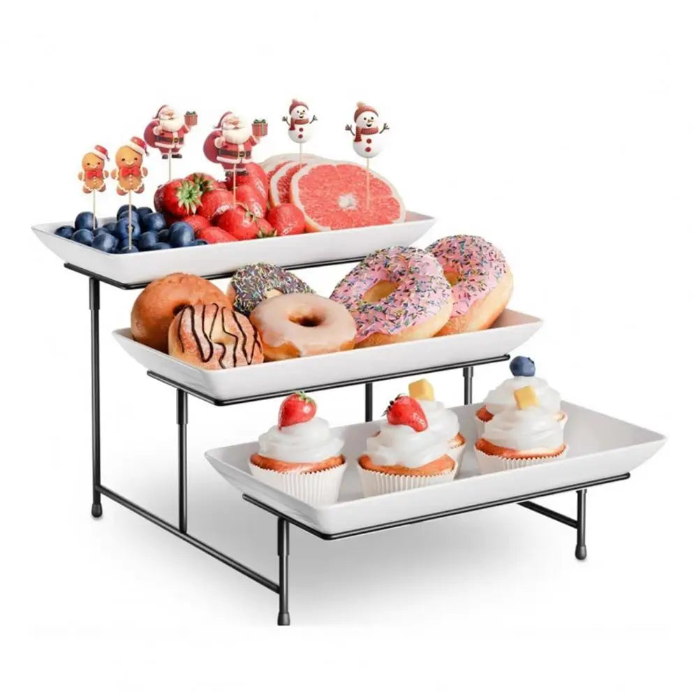 An elegant three-tier serving rack displaying various cupcakes and donuts.