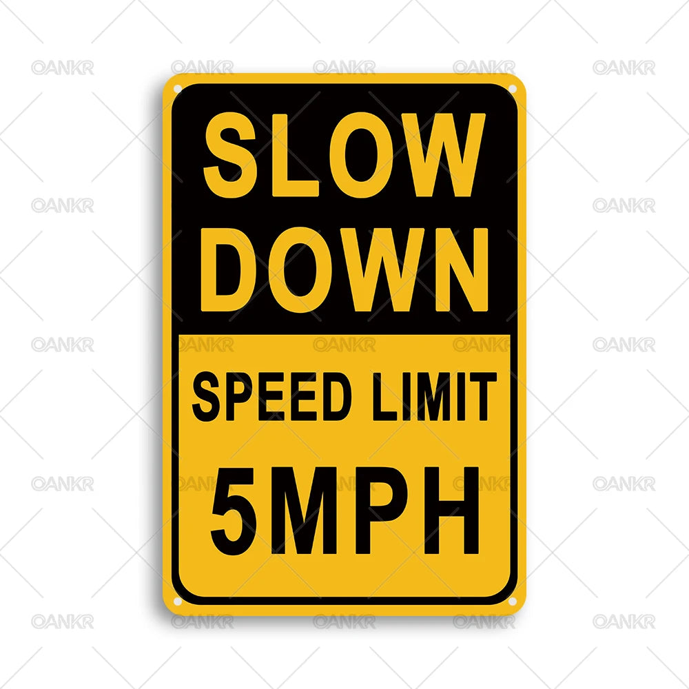 A yellow and black rectangular sign with the text SLOW DOWN SPEED LIMIT 5MPH.