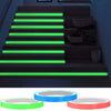 A set of glow-in-the-dark safety warning tape rolls in green, blue, and orange.