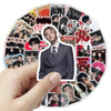 A hand holds a round sticker pack featuring various photos and designs related to BT21 Graffiti.