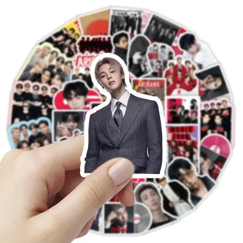 A hand holds a round sticker pack featuring various photos and designs related to BT21 Graffiti.