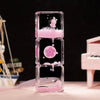 A clear glass hourglass filled with pink liquid sand, featuring a small panda figurine.