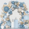 A balloon arch kit featuring dusty blue and sand white balloons with gold confetti accents.
