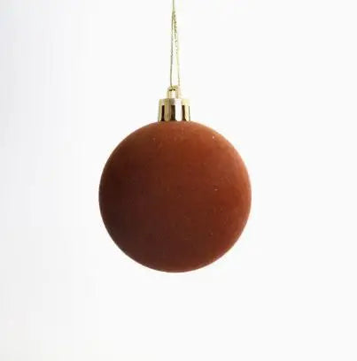 A round, reddish-brown velvet flocked Christmas tree ornament hanging by a gold string.