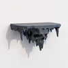 A dark, melted skull wall shelf with dripping edges, displayed against a white background.