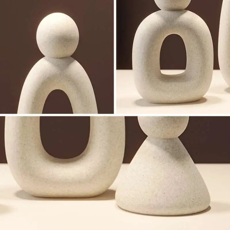 A set of smooth, white resin statues depicting stylized human figures in various poses and sizes.