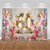 A glamorous balloon backdrop for a 60th birthday featuring gold, silver, and pink balloons and floral decorations.