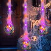 Halloween glowing spider web decoration featuring light-up eggs hanging from vertical strands