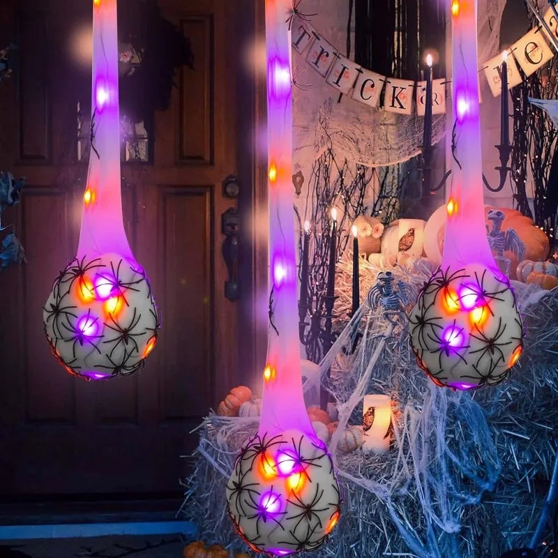 Halloween glowing spider web decoration featuring light-up eggs hanging from vertical strands