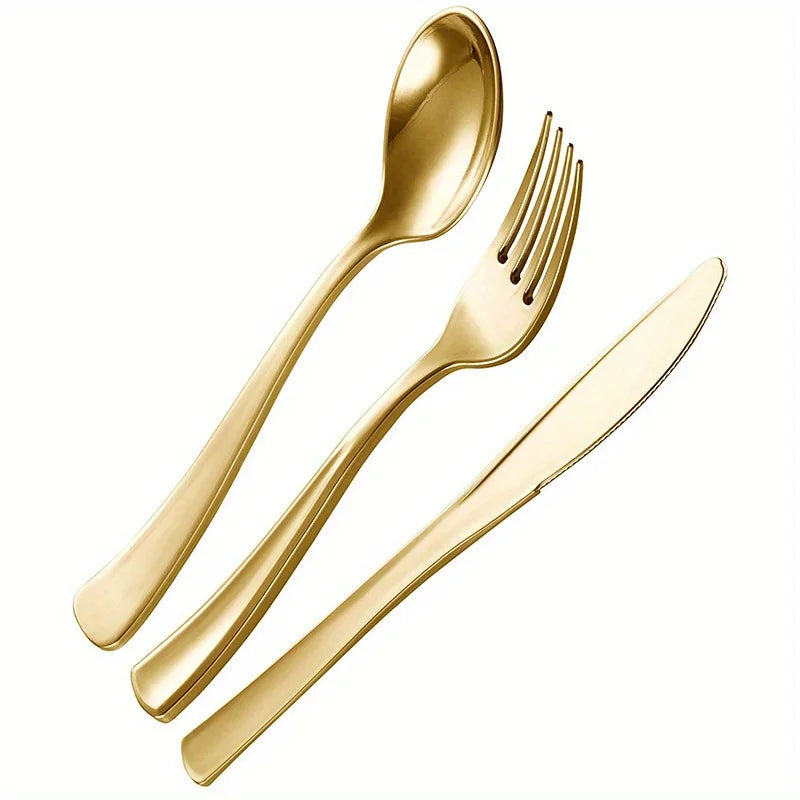 A set of gold disposable cutlery including forks, spoons, and knives arranged diagonally.