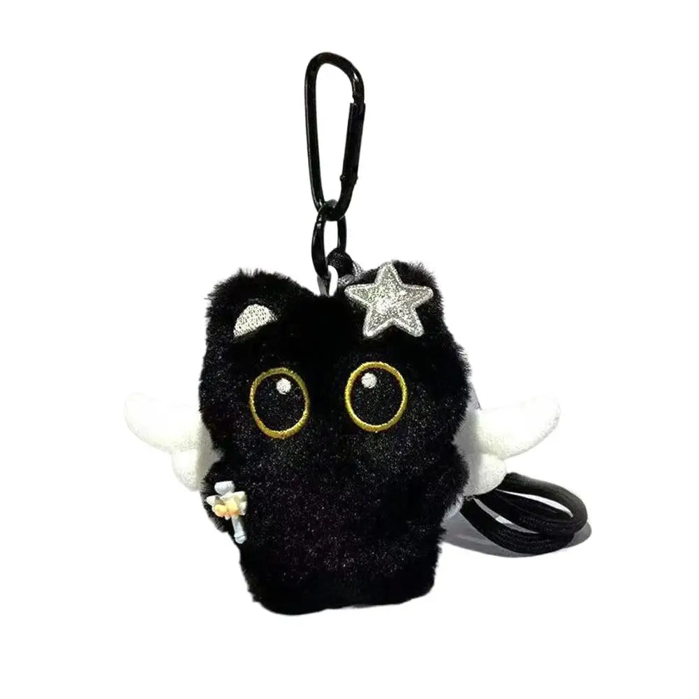 A black seal plush keychain with gold eyes and a silver star charm.