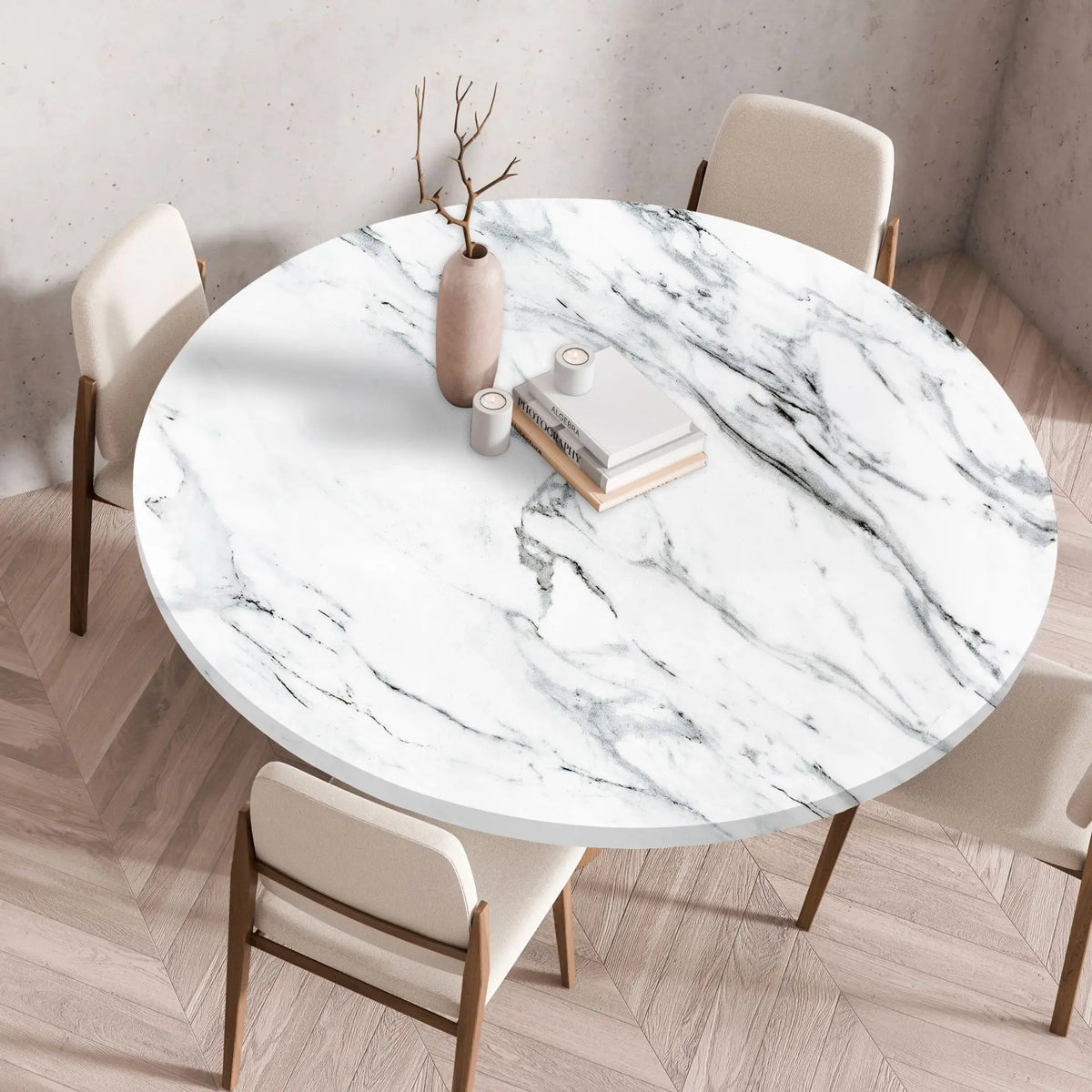 A round marble print tablecloth is displayed on a wooden table in a bright room with modern chairs.