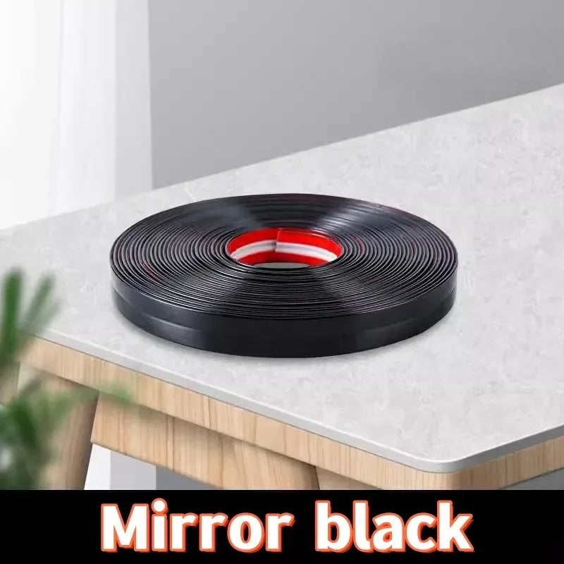 A roll of black self-adhesive PVC edge guard strip for cabinets, tables, and corners.