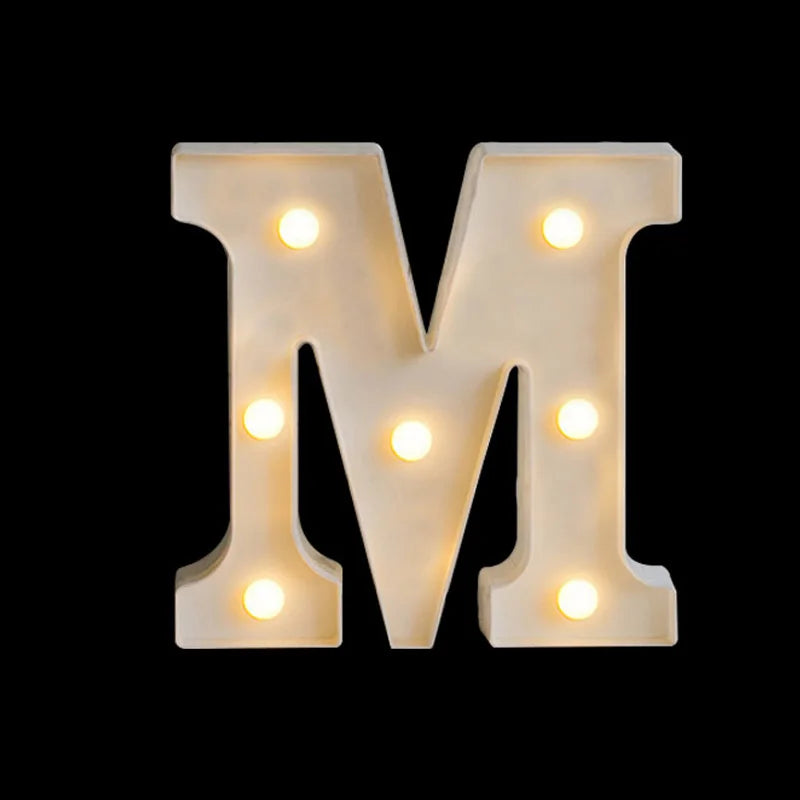 A large, illuminated letter M made of warm white LED alphabet light against a black background.
