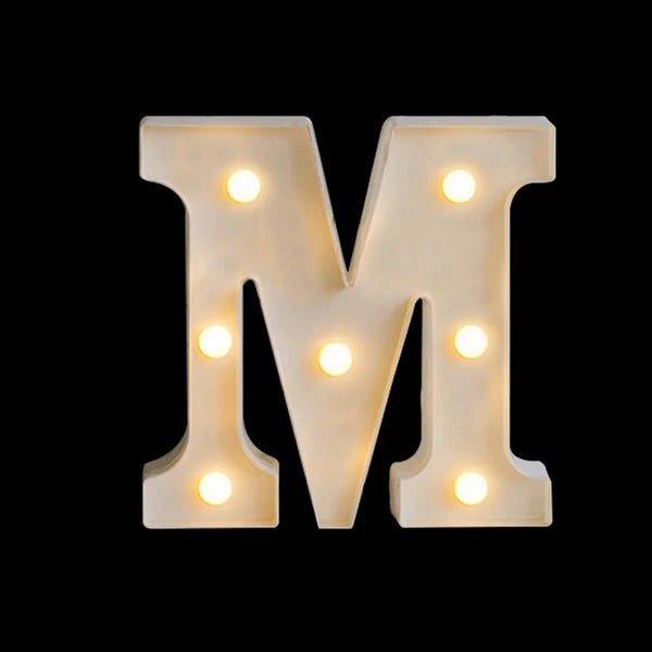 A large, illuminated letter M made of warm white LED alphabet light against a black background.