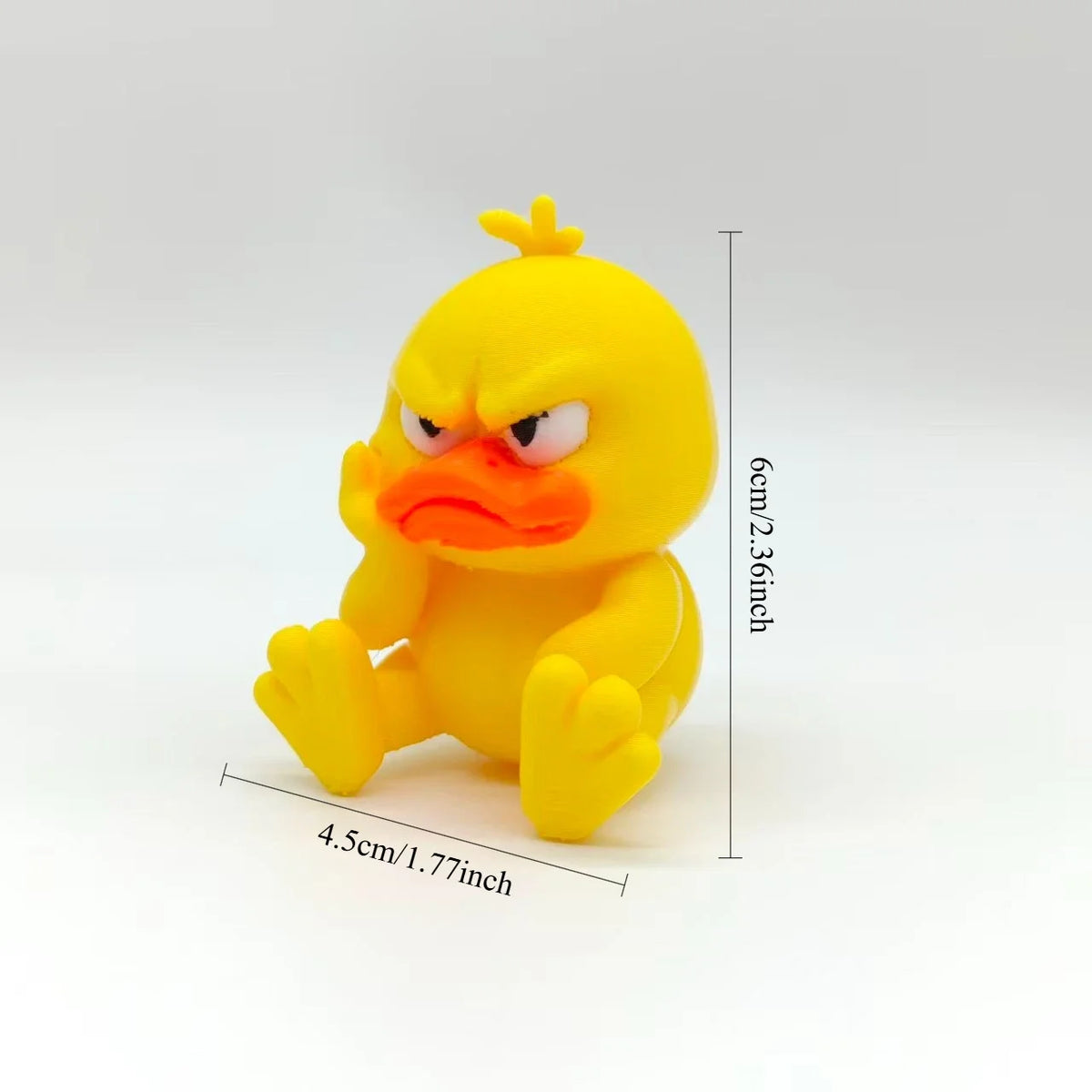 A yellow 3D printed figurine of an angry duck with bright orange facial features.