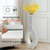 Tall silver mirrored vase with a crushed diamond finish displayed in a bright room.