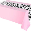 Pink cow print western tablecloth draped on a table.