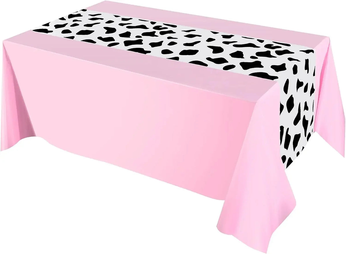 Pink cow print western tablecloth draped on a table.