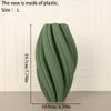 A tall, olive green plastic vase with a textured wave pattern shown against a white background.